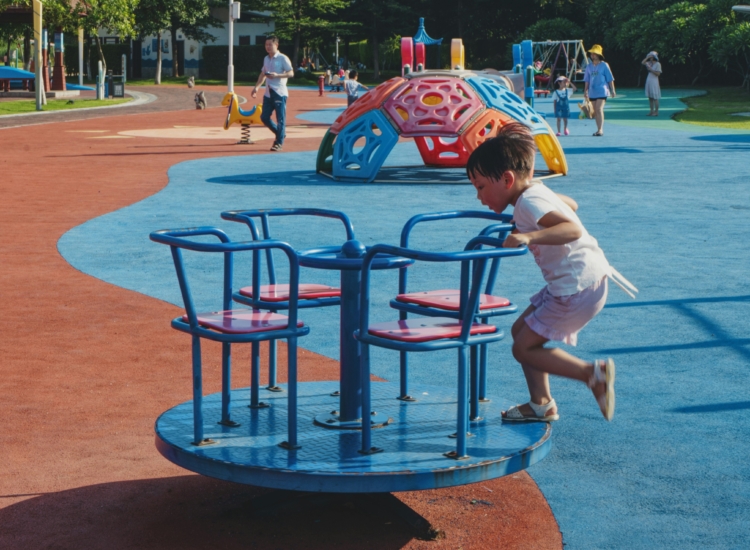little kid playing at the park